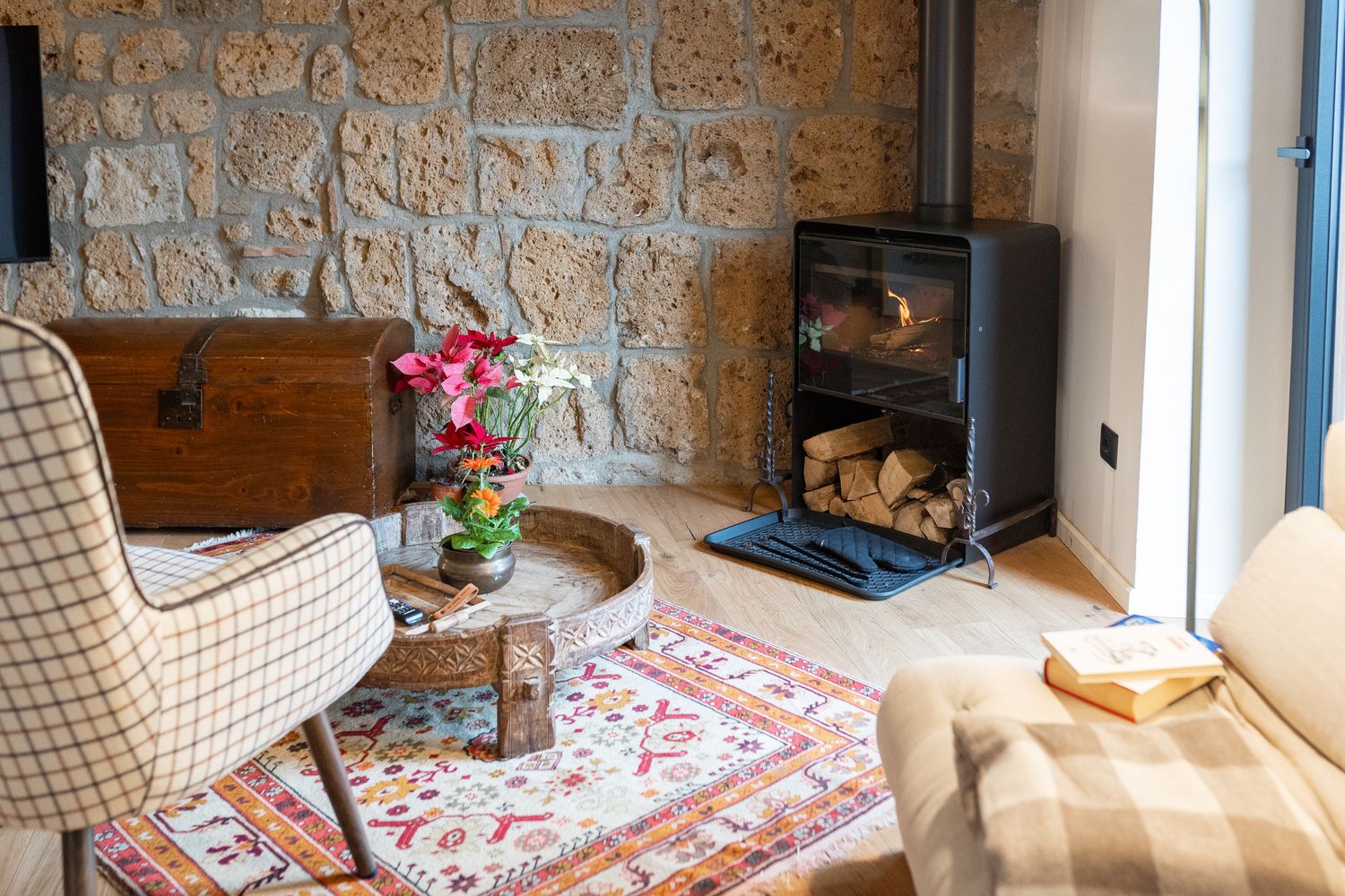 Living area with stone wall and wood-burning stove